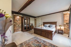 a bedroom with a bed and a brick wall at Casa Ra in Podgorica