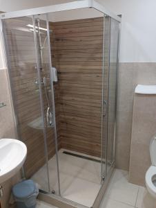 a shower with a glass door in a bathroom at Penzión Réva in Turna nad Bodvou