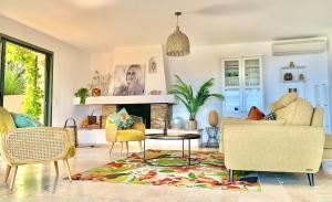 a living room with a couch and a table at Découvrez la Villa « The View » in Cavalaire-sur-Mer +54 photos