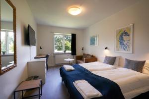 Ένα ή περισσότερα κρεβάτια σε δωμάτιο στο Hotel Skanderborghus