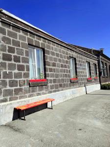 a bench sitting in front of a brick building at Unoyan Guest House in Gyumri