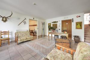 a living room with couches and a table at Albergo Casa Alpina San Luigi in Campodolcino