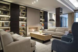 a living room with two couches and a fireplace at NH Collection Buenos Aires Crillón in Buenos Aires