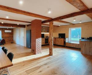 an open living room with wooden walls and wooden floors at Pihlaka Jahimaja in Järtsaare