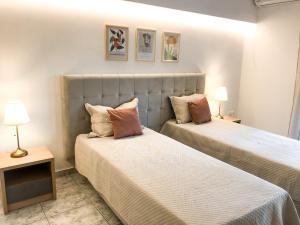 a bedroom with two beds with pillows at Luxury Villa Anemone with private pool in Pastida