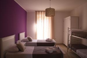 a bedroom with two beds and a window at La Dimora del Croccio - Gole del Calore in Felitto