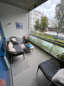 a balcony with two chairs and a table at Cozy centre apartament Kuopio in Kuopio