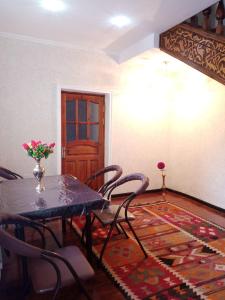 a dining room with a table and chairs and a door at Hotel Sohibqiron Boutique in Bukhara