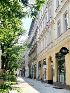 an empty city street with buildings and trees at aleja Wojska Polskiego 40 in Szczecin