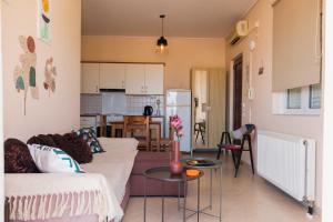 a living room with a couch and a table at Sunday Apartments in Nafplio