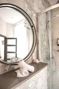 a bathroom with a mirror and a towel at Lace Market Hotel in Nottingham