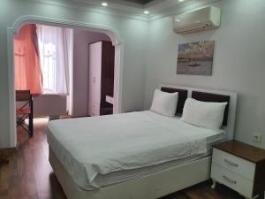 a bedroom with a large bed with white sheets at sea star duran apart in Istanbul