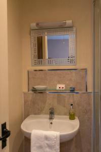 a bathroom with a sink and a mirror at The Kings Head Hotel in Abergavenny