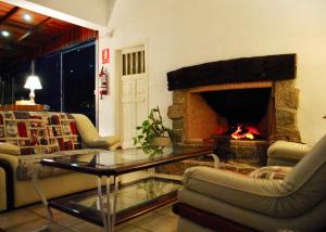 a living room with a fireplace and a table and chairs at Blu Inn in Punta del Este