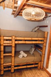 a room with a wooden bunk bed with a light at Tiki Limbo in Montañita