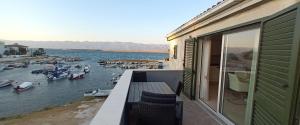 a balcony with a view of a marina with boats at Apartments-Sana-2 in Vir