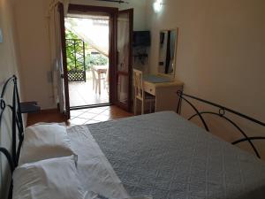 a bedroom with a bed and a door to a patio at Residence Luna Rossa in Costa Rei
