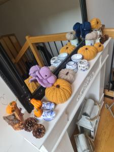 a shelf with various knitted items on it at Ammerwald Alm in Plansee