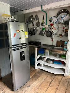 a kitchen with a stainless steel refrigerator in a room at Flor de la selva in Puerto Nariño