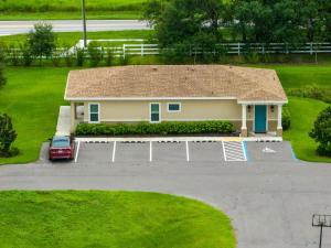 a house with a car parked in a parking lot at HS#2- Modern Studio next to Premier Sports Complex in Bradenton