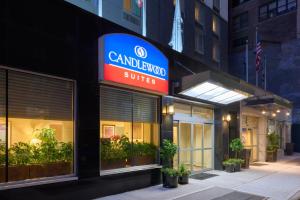 a building with a sign that reads cameluana suites at Candlewood Suites NYC -Times Square, an IHG Hotel in New York