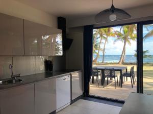 a kitchen with a view of the ocean at Be On The Beach in Sainte-Anne