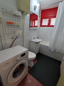 a bathroom with a washing machine and a toilet at Banjica 2 in Voždovac