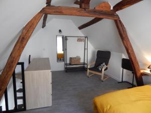 Cette chambre mansardée comprend un lit et un miroir. dans l'établissement L'étonnante, à Margny-lès-Compiègne