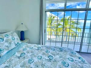 a bedroom with a bed with a view of the ocean at Sunset Cove - Vacation In Paradise! in Nassau