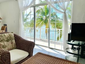 a living room with a couch and a large window at Sunset Cove - Vacation In Paradise! in Nassau