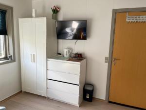 a white cabinet with a tv on top of it at Pavillon Greve in Greve