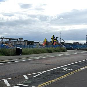 an empty street with a playground in the background at Maze Great Escape in Ayr