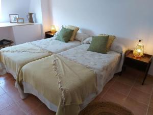 a bedroom with two beds with green pillows at APARTAMENTO ESTORDE - COSTA DA MORTE in Cee