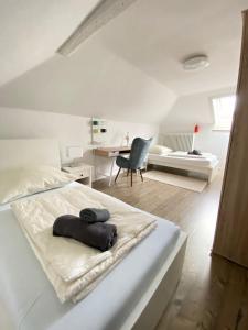 a white bedroom with a bed and a desk at Schulz Apartments Zentrum in Bonn