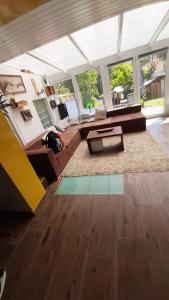 a living room with a couch and a table at WOHLFÜHLOASE - Zimmer, Appartment - im Herzen STARNBERGS in Starnberg