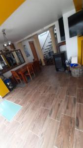 a living room with a wooden floor and chairs at WOHLFÜHLOASE - Zimmer, Appartment - im Herzen STARNBERGS in Starnberg