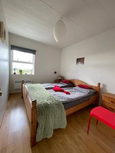een slaapkamer met een bed en een rood voorwerp erop bij Guest House Svetlana in Hella