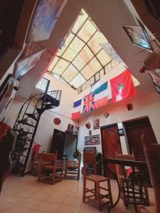 a room with a staircase and chairs and flags at Riad chaoui house in Marrakesh