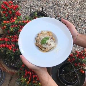 a person holding a white plate with a plant in it at Agriturismo Borgo Furma in Enna