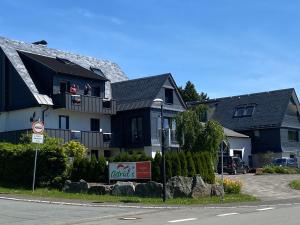 a house with a sign in front of it at Astrid's Appartements in Winterberg