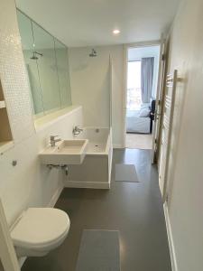 a bathroom with a sink and a toilet and a mirror at Rotunda - New Street, City Centre, Birmingham in Birmingham