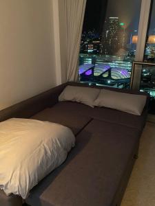 a bed in a room with a view of a city at Rotunda - New Street, City Centre, Birmingham in Birmingham