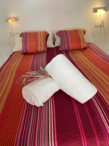 a bed with two white pillows on it at Apartamento Vista Altillo in Almuñécar