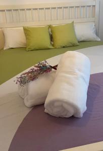 a bed with white blankets and pillows on it at Apartamento Vista Altillo in Almuñécar
