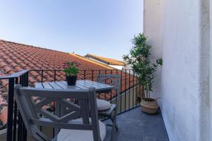 - un balcon avec une table et des chaises dans l'établissement Porta 25 Guesthouse, à Covilhã
