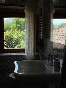 bagno con lavandino e finestra di Le Farine Del Maestro a Barete