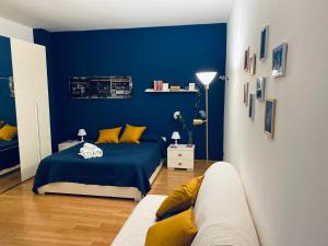 a blue bedroom with a bed and a couch at Chiara Guest House - Nuova Metro blu in Milan