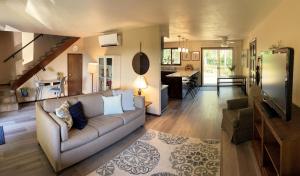 a living room with a couch and a kitchen at Fern Hill Retreat in Chehalis +28 photos