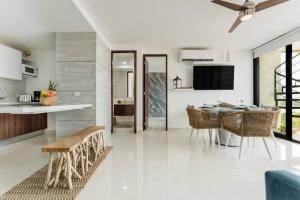 a kitchen and living room with a table and chairs at ☆Brand new 2BR PH by CASA PARAISO☆ in Cancún