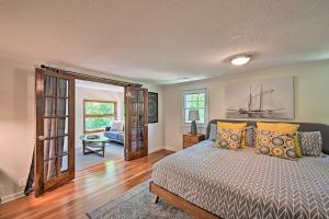 a bedroom with a bed and a living room at Chic House with Private Dock on Lake Hartwell! in Townville